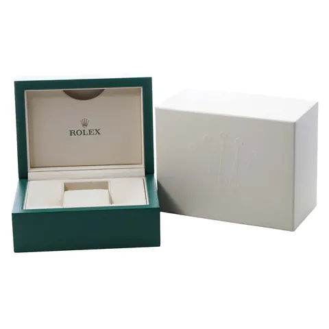 Open green Rolex presentation box beside its outer sleeve