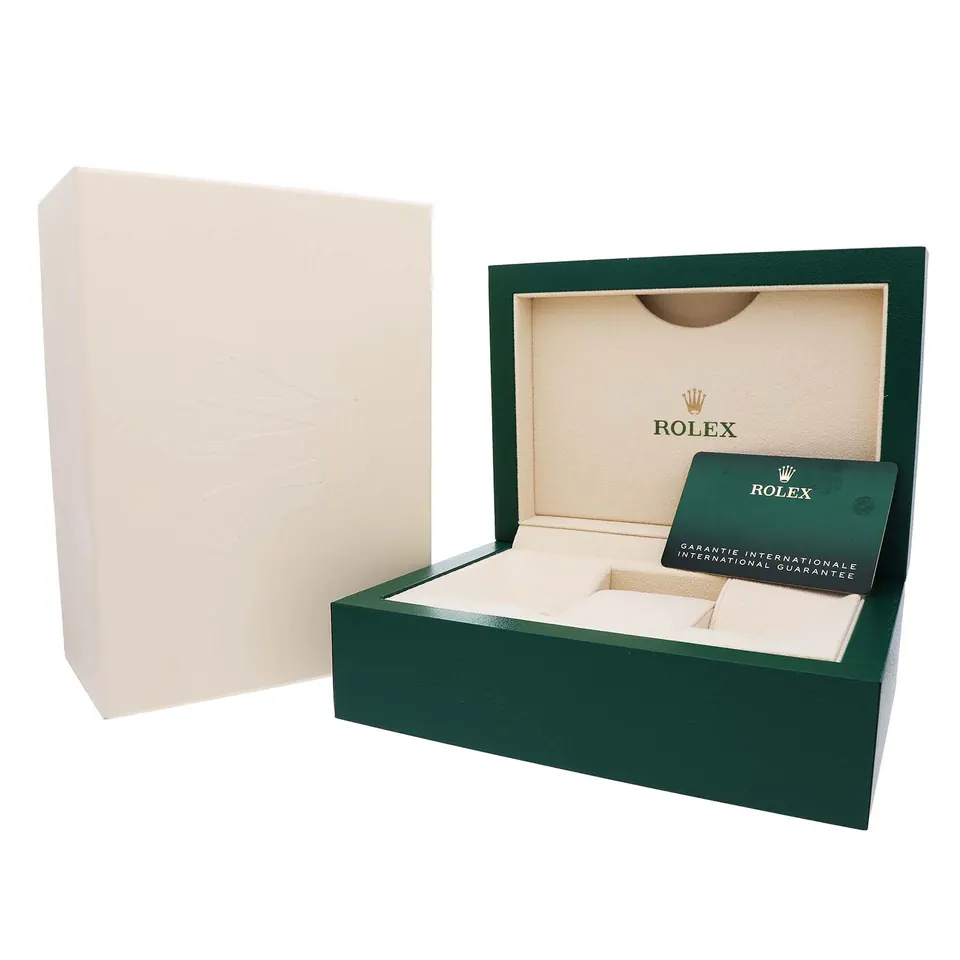 Green Rolex presentation box with outer sleeve and a Rolex warranty card