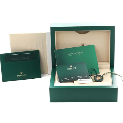 Green Rolex box with warranty card and booklet